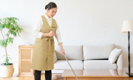 A housekeeper mopping the floor